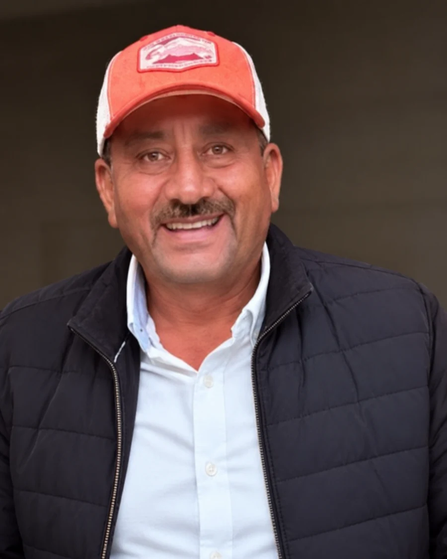 Tony smiling in his red cap and dark jacket